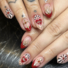 Short Almond Red French Nails with Heart, Flame, and Cross Accents