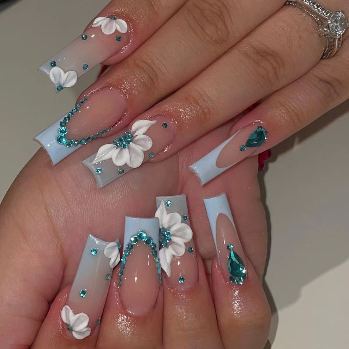 Elegant Light Blue French Nails with Crystal Chain and Flower Accents