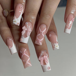 Classic White French Nails with Pearl, Bow, and Flower Accents