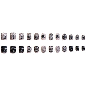 Skin Tone Matte Square Nails with Black Eyes Design